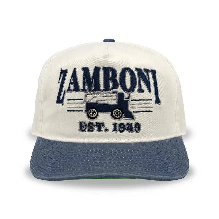 Snapback cap in cream cotton with a washed navy brim and embroidered Zamboni logo; Adult Zamboni Ride-Along Costume style detail.