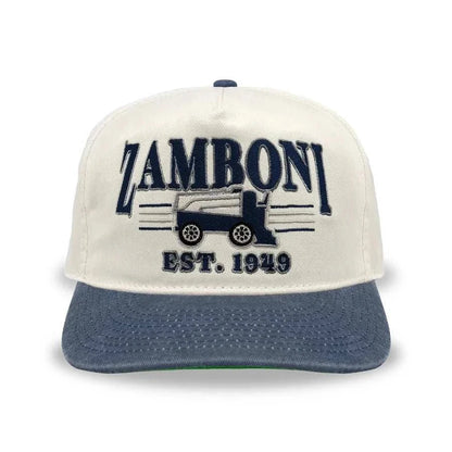 Snapback cap in cream cotton with a washed navy brim and embroidered Zamboni logo; Adult Zamboni Ride-Along Costume style detail.