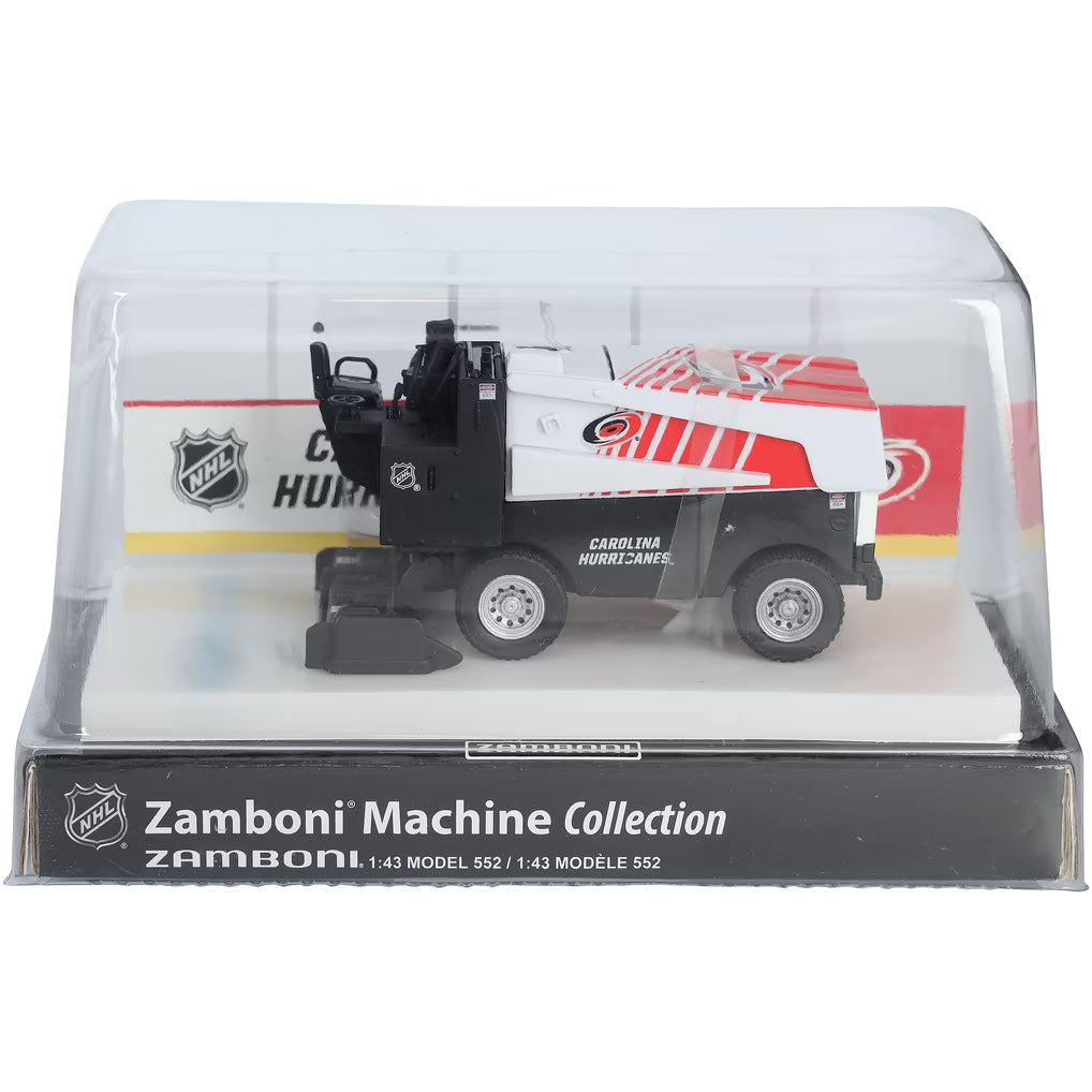Die-cast Zamboni collectible with a white and red Carolina Hurricanes design, displayed in a clear arena stand; Adult Zamboni Ride-Along Costume is not shown.
